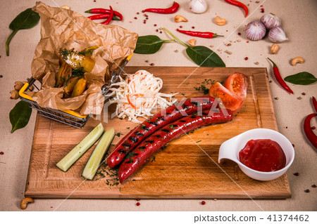 Grilled sausages with cucumber and ketchup 41374462