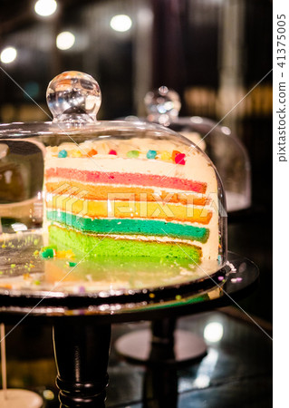 Rainbow cake under glass bell dome 41375005