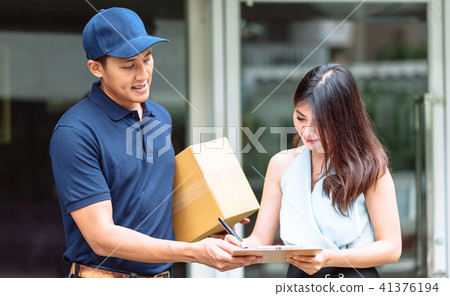 Delivery man giving clipboard for woman to sign Delivery man giving clipboard for woman to sign 41376194