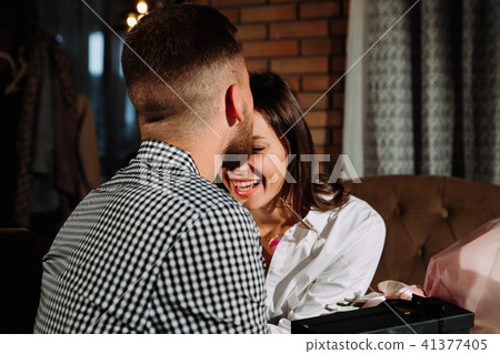 a couple dinners in a restaurant a man kisses a woman 41377405