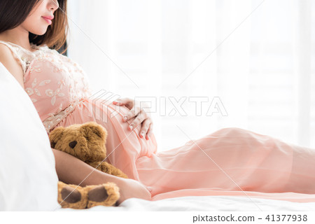 Pregnant woman holding pregnant belly Pregnant woman holding pregnant belly 41377938