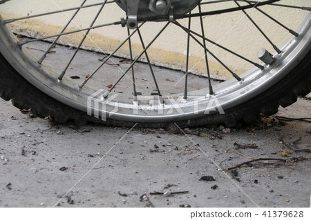 Close up wheel flat tire of the motorcycle old Close up wheel flat tire of the motorcycle old 41379628