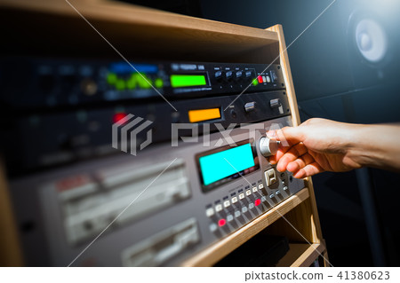 sound engineer adjusting audio equipment in studio 41380623