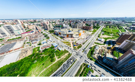 Aerial city view with crossroads and roads, houses, buildings, parks and parking lots. Sunny summer Aerial city view with crossroads and roads, houses, buildings, parks and parking lots. Sunny summer 41382488