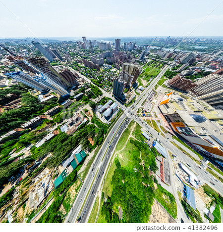 Aerial city view with crossroads and roads, houses, buildings, parks and parking lots. Sunny summer Aerial city view with crossroads and roads, houses, buildings, parks and parking lots. Sunny summer 41382496