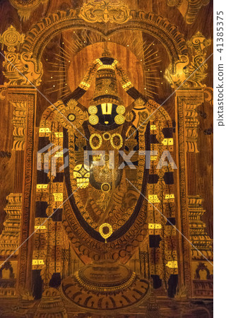 Wooden painting of Lord Tirupathi at hotel lobby Wooden painting of Lord Tirupathi at hotel lobby 41385375