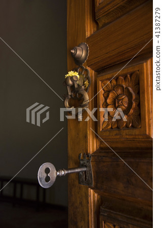 Big key and wooden door at the entrance of a templ 41387279