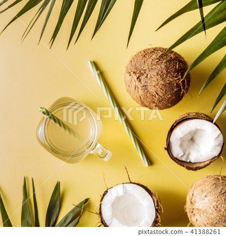 Coconut water and coconuts on a pastel background. Coconut water and coconuts on a pastel background. 41388261