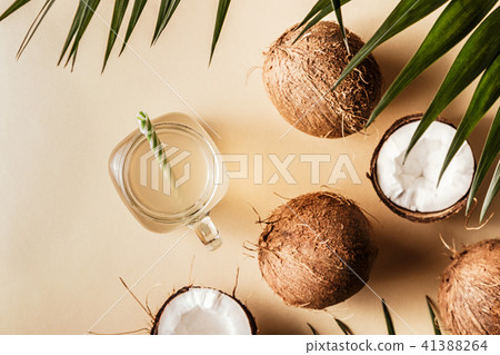 Coconut water and coconuts on a pastel background. Coconut water and coconuts on a pastel background. 41388264