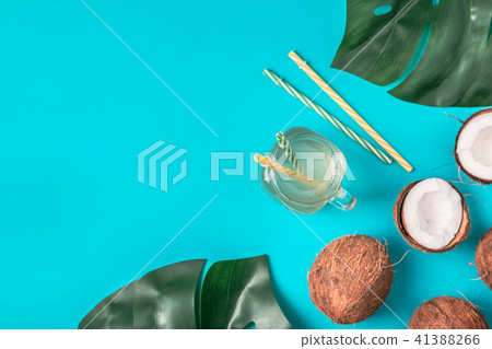 Coconut water and coconuts on a pastel background. Coconut water and coconuts on a pastel background. 41388266