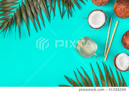 Coconut water and coconuts on a pastel background. Coconut water and coconuts on a pastel background. 41388269