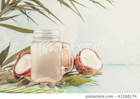 Coconut water and coconuts on a pastel background. Coconut water and coconuts on a pastel background. 41388274