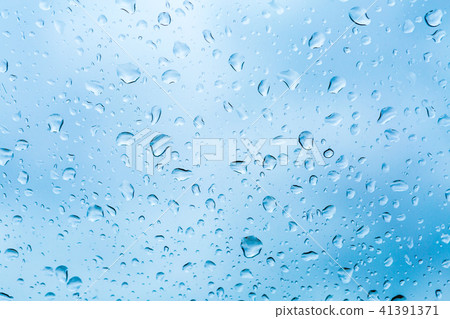 Drops of rain on blue glass background Drops of rain on blue glass background 41391371
