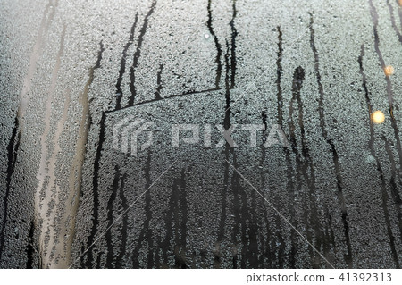 condensate flowing water on the window glass  41392313