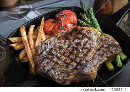 grilled rib eye steak on pan 41392341