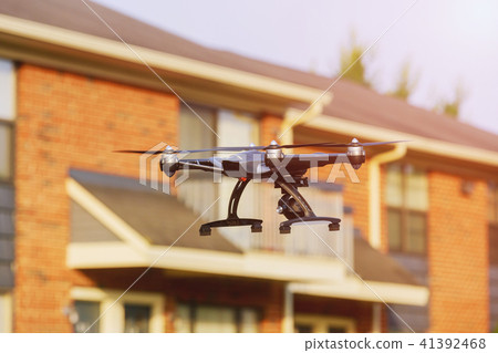 drone with professional cinema camera flying 41392468