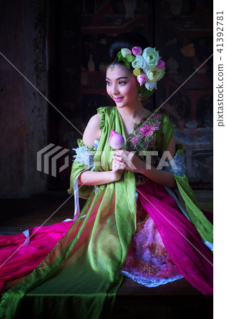 Beautiful Asian woman lotus on hand with Thai Beautiful Asian woman lotus on hand with Thai 41392781