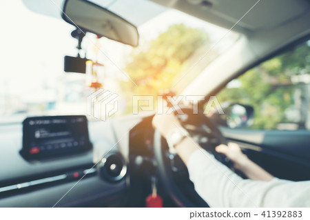 Blurred Picture of Women Driving a Car on the Road 41392883