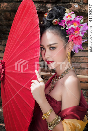 Beautiful Thai girl in traditional dress costume Beautiful Thai girl in traditional dress costume 41393077