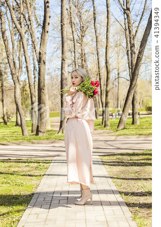 Perfect woman in pink silky raincoat  41394349