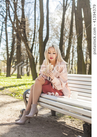 Cute Young Woman with Street Food Outdoors 41394379