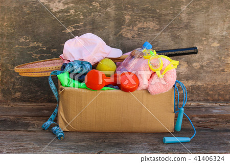 Cardboard box with sports stuff on old wooden Cardboard box with sports stuff on old wooden 41406324