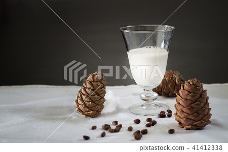 Glass Pine nuts vegan milk and cedar cones. Glass Pine nuts vegan milk and cedar cones. 41412338