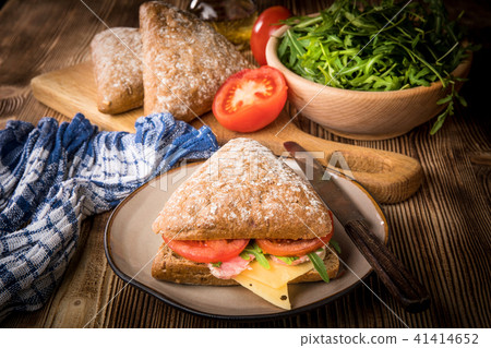 Triangular sandwich with cheese, ham and tomato. 41414652