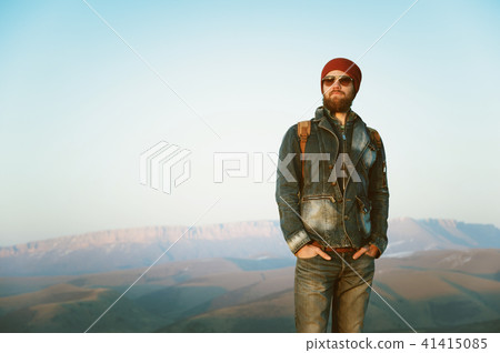 Hipster young man with beard and mustache wearing sunglasses posing against the background of Hipster young man with beard and mustache wearing sunglasses posing against the background of 41415085