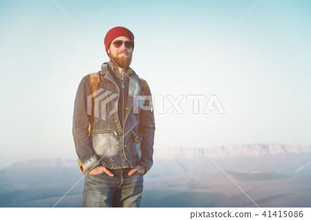 Hipster young man with beard and mustache wearing sunglasses posing against the background of Hipster young man with beard and mustache wearing sunglasses posing against the background of 41415086