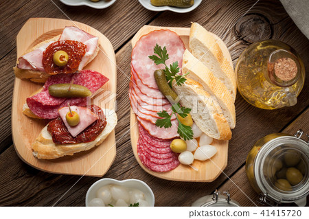Tapas with sliced sausage, salami, olives Tapas with sliced sausage, salami, olives 41415720