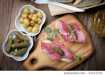 Tapas with sliced sausage, salami, olives Tapas with sliced sausage, salami, olives 41415743