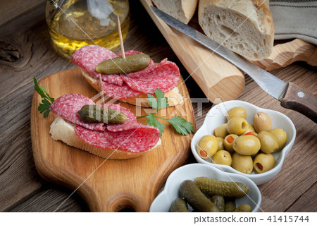 Tapas with sliced sausage, salami, olives Tapas with sliced sausage, salami, olives 41415744