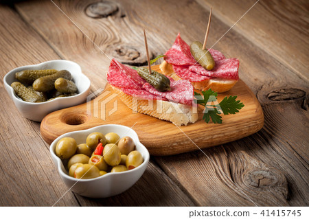 Tapas with sliced sausage, salami, olives Tapas with sliced sausage, salami, olives 41415745