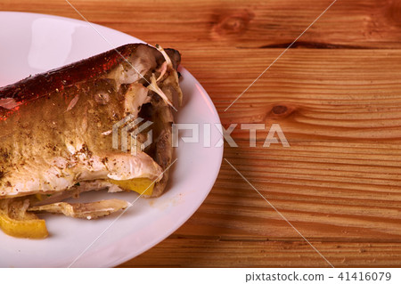 Baked fish with lemon, spices and herbs Baked fish with lemon, spices and herbs 41416079