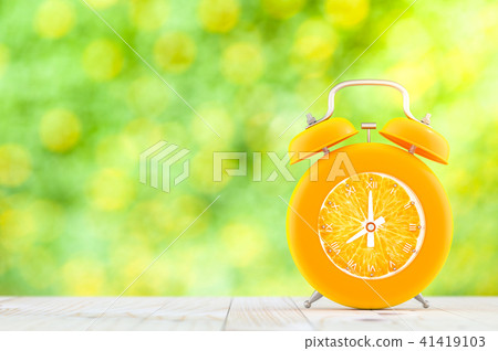 Orange alarm clock on wooden table Orange alarm clock on wooden table 41419103
