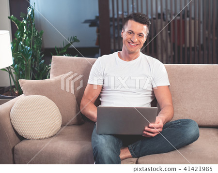 Cheerful guy spending evening at home Cheerful guy spending evening at home 41421985
