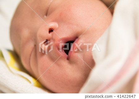 Asian new born baby falling into a deep sleep 41422647