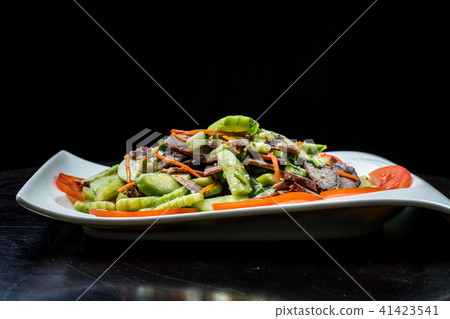 Chinese cuisine, boiled beef with cucumber and tomato in white plate on black background 41423541