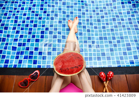 Beautiful bikini girl relaxing in swimming pool. 41423809