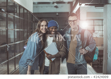 Joyful creative people are standing and laughing Joyful creative people are standing and laughing 41424009