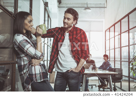 Pleasant colleagues are talking with smile Pleasant colleagues are talking with smile 41424204