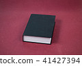 Big Black hardcover closed book on a red 41427394