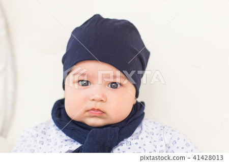 Adorable baby boy in sunny bedroom. Newborn child relaxing Adorable baby boy in sunny bedroom. Newborn child relaxing 41428013