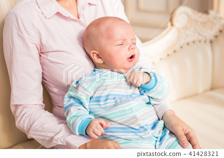Adorable baby boy in sunny bedroom. Newborn child relaxing Adorable baby boy in sunny bedroom. Newborn child relaxing 41428321