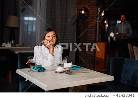 a beautiful girl is waiting for a guy on a date 41428341