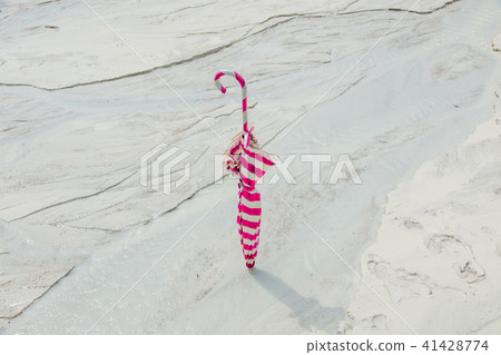 vintage red umbrella on sand 41428774