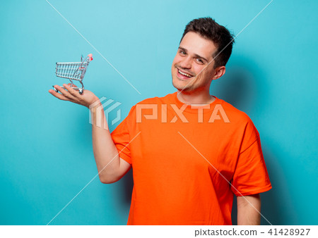 man in orange t-shirt with shopping cart man in orange t-shirt with shopping cart 41428927