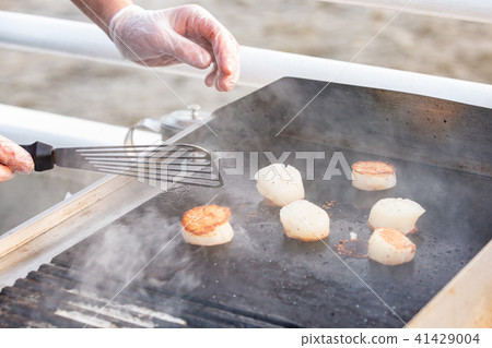 professional chef cooking fish on a barbeque. Portionally fried pieces of fish. The cooking process 41429004