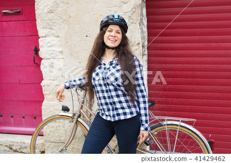 Young smiling woman with bicycle looking camera 41429462